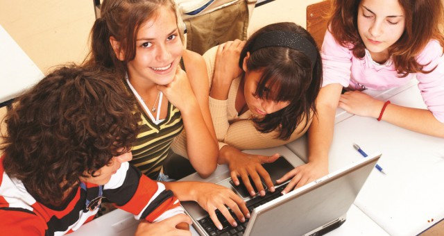 Four girls learn fast on computer together.