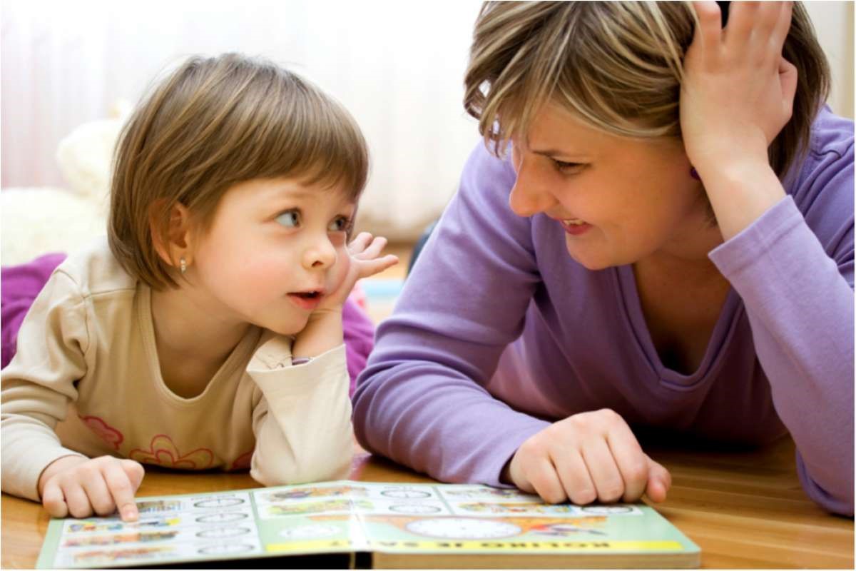 A little girl looks at her mom, showing one big way that people grow alike naturally