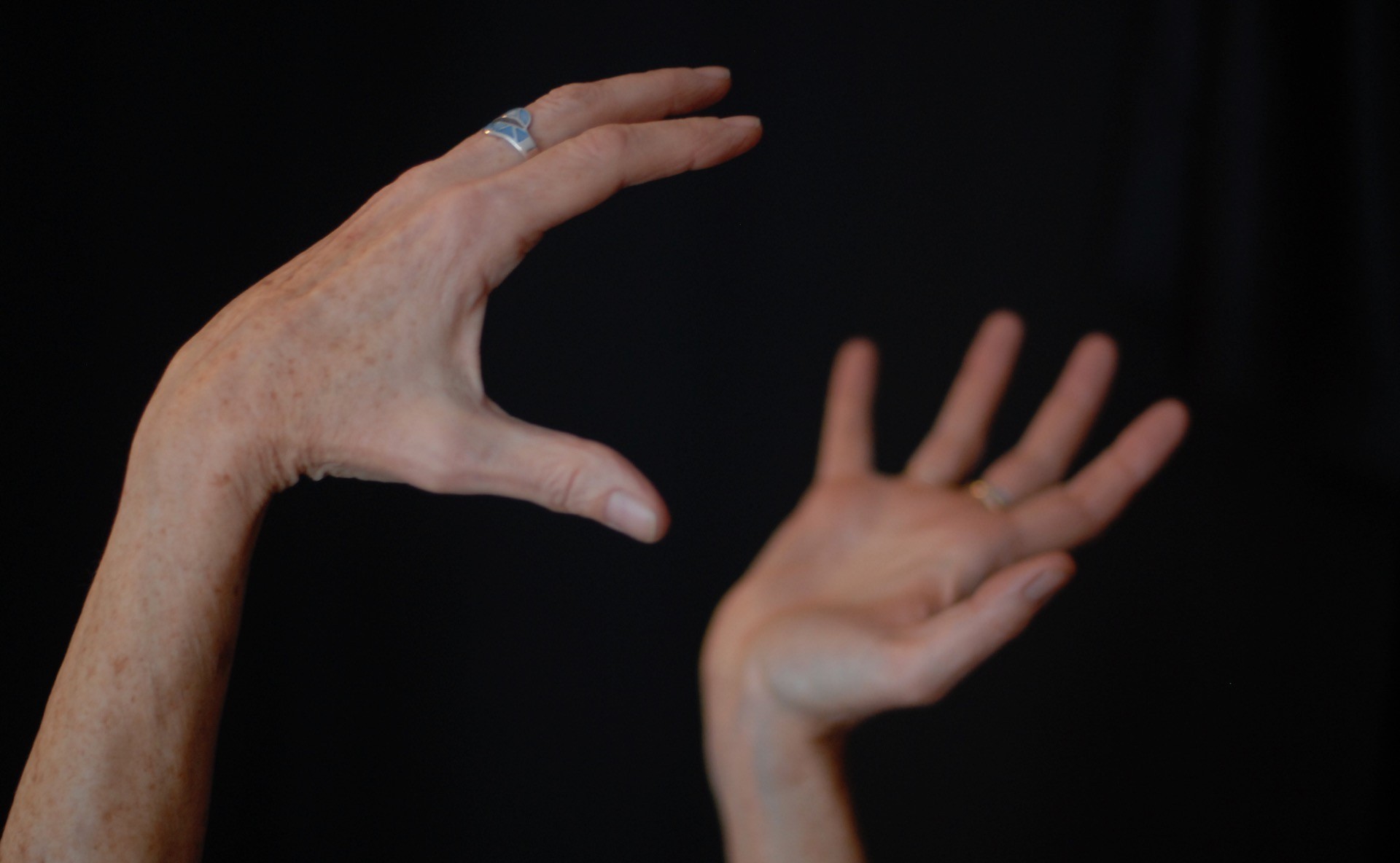 A storyteller’s hands grasp an unseen object, illustrating nonfiction narratives, which are complex and embedded