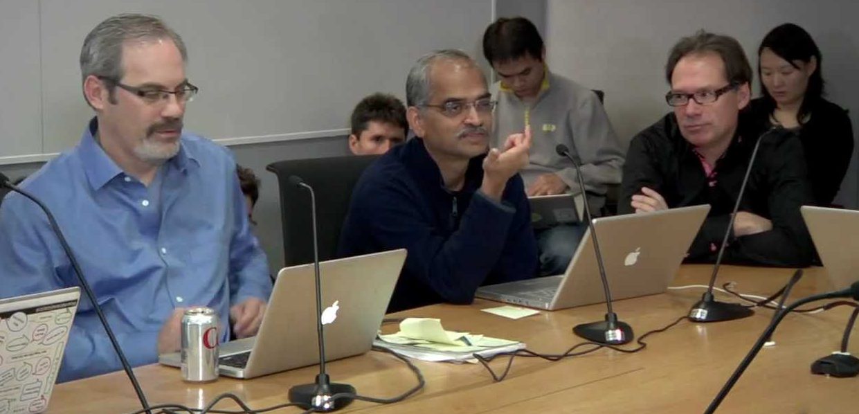 Google meeting with laptops everywhere and video shared online, illustrating Google's data collection, sharing, and use.