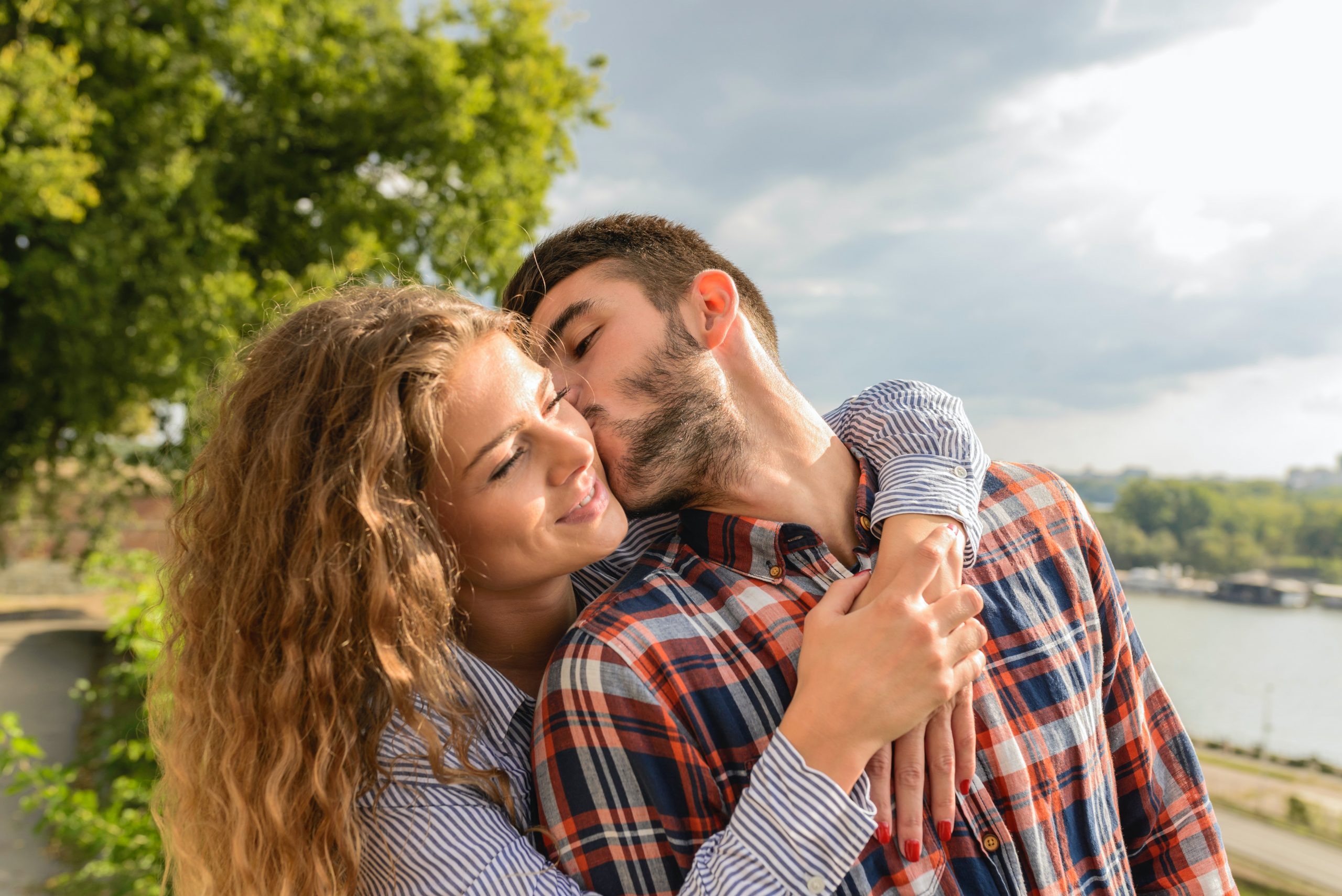 man and woman embrace and kiss